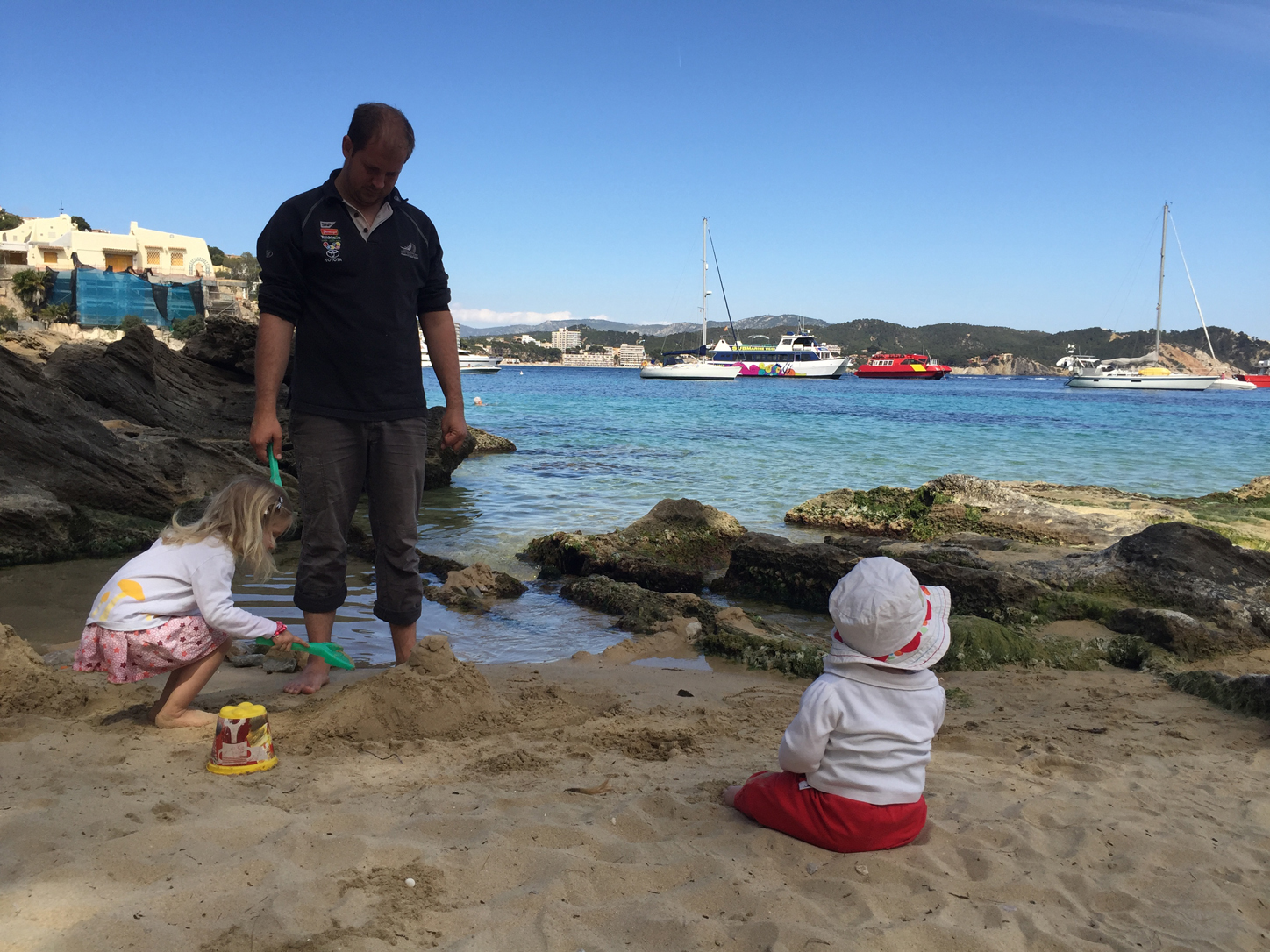 BabyPaw furtively munching a fistful or three of sand while Transportation and I are busy with the castle.