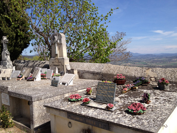 Apparently French people leave ceramic flowers and little 'souvenirs' plates on graves instead of real flowers. Makes for some very colorful arrangements.