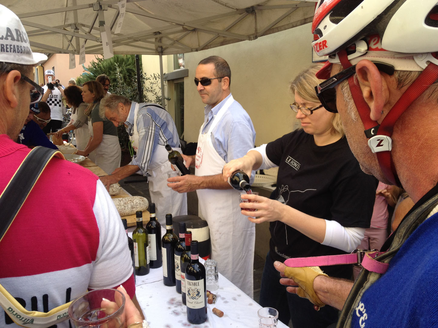 Catering's sister doing an excellent job giving out wine to the bikers.