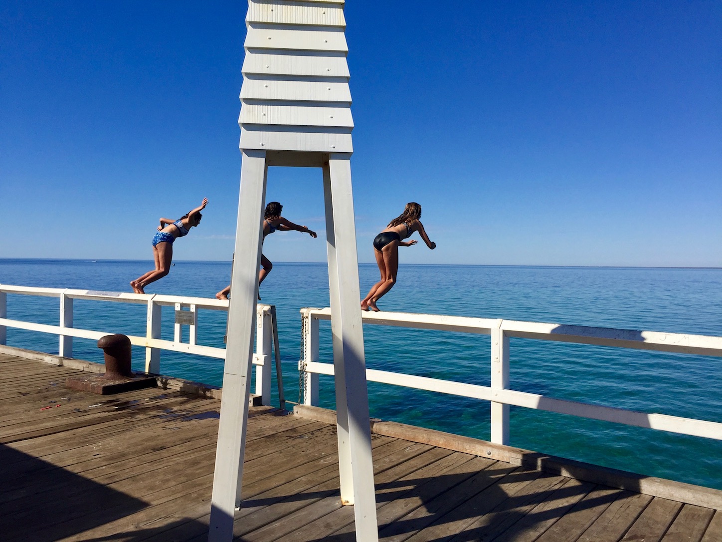 Bathers jumping off the jetty.